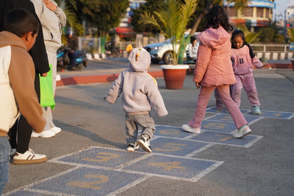 Children playing hopscotch in the playground