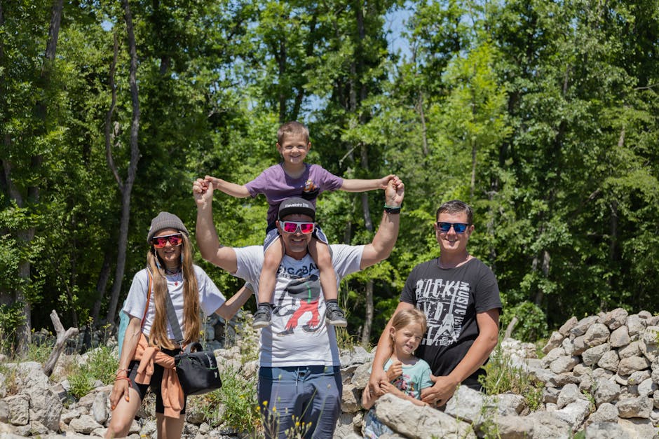 A joyful family enjoying a sunny day outdoors, captured in a lively and happy moment.