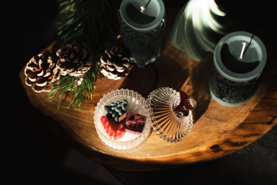 A warm, festive display of candles and holiday decor captures the essence of Christmas ambiance.